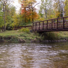 Happy Humpday! It is lovely outdoors at Oak Hill Apartments today. a bridge over a river in a forest