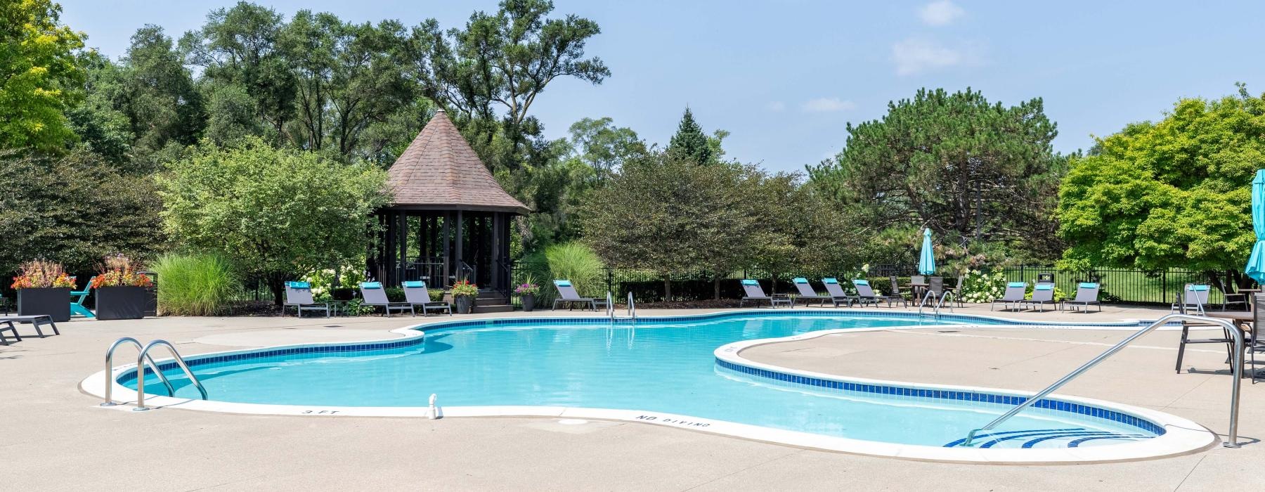 a pool with a gazebo in the background