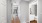 a bathroom and hallway with white walls